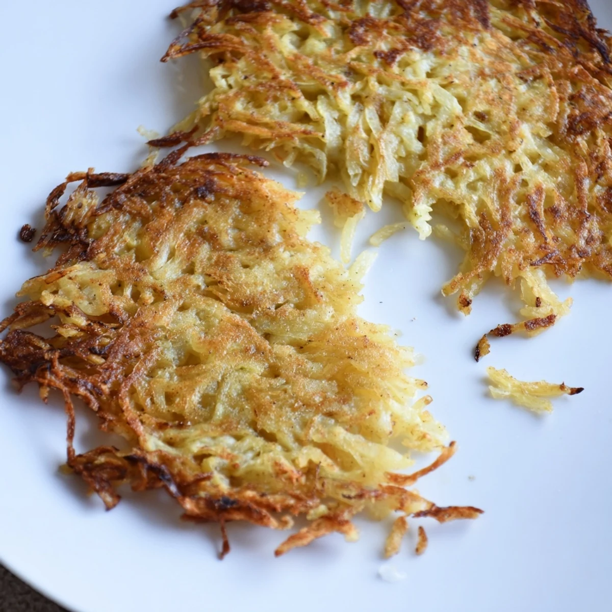A close-up shot of German potato pancakes, showing their beautifully browned, textured surface.