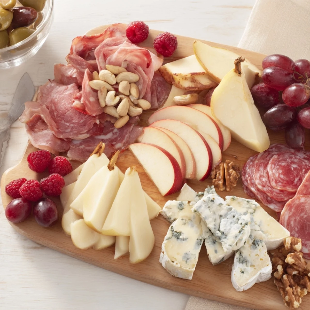 A delightful Lace & Pearls Elegant Board with colorful fruits, artisan cheeses, and savory charcuterie.