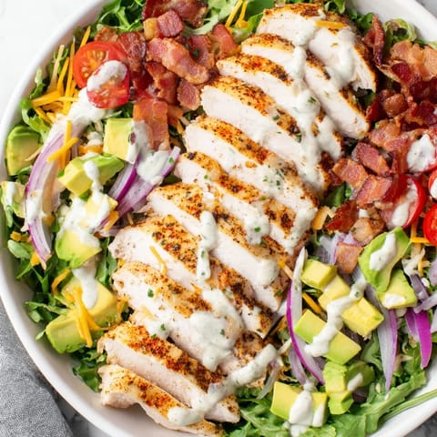 A close-up shot of the flavorful Crispy Bacon Chicken Salad with bacon, chicken and avocado.