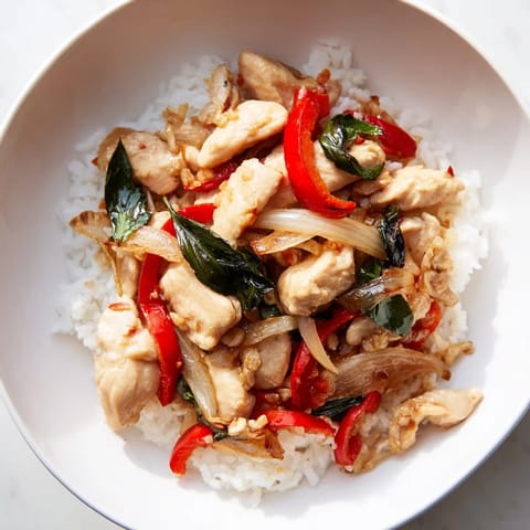 Aromatic Thai Basil Chicken Bowls, ready to eat, served with fluffy jasmine rice.