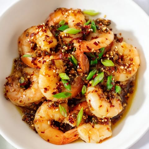 A vibrant close-up of Korean Garlic Butter Shrimp, ready to be served with fresh scallions and sesame seeds.