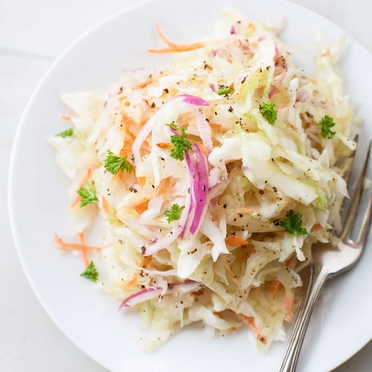 Refreshing sauerkraut and apple slaw served in a vibrant bowl, perfect for picnics.